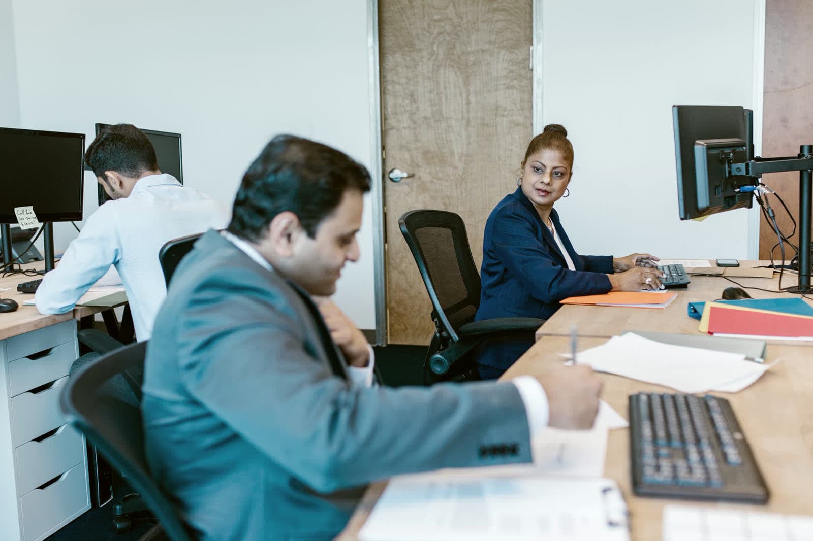 A small office team at work at their desks
