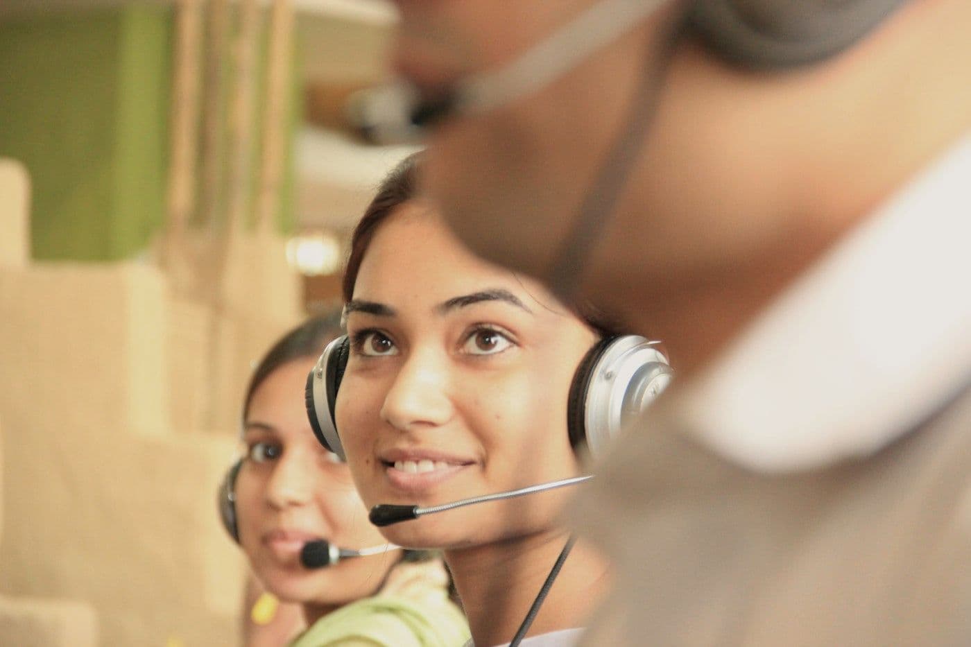 Support agents with headsets at work