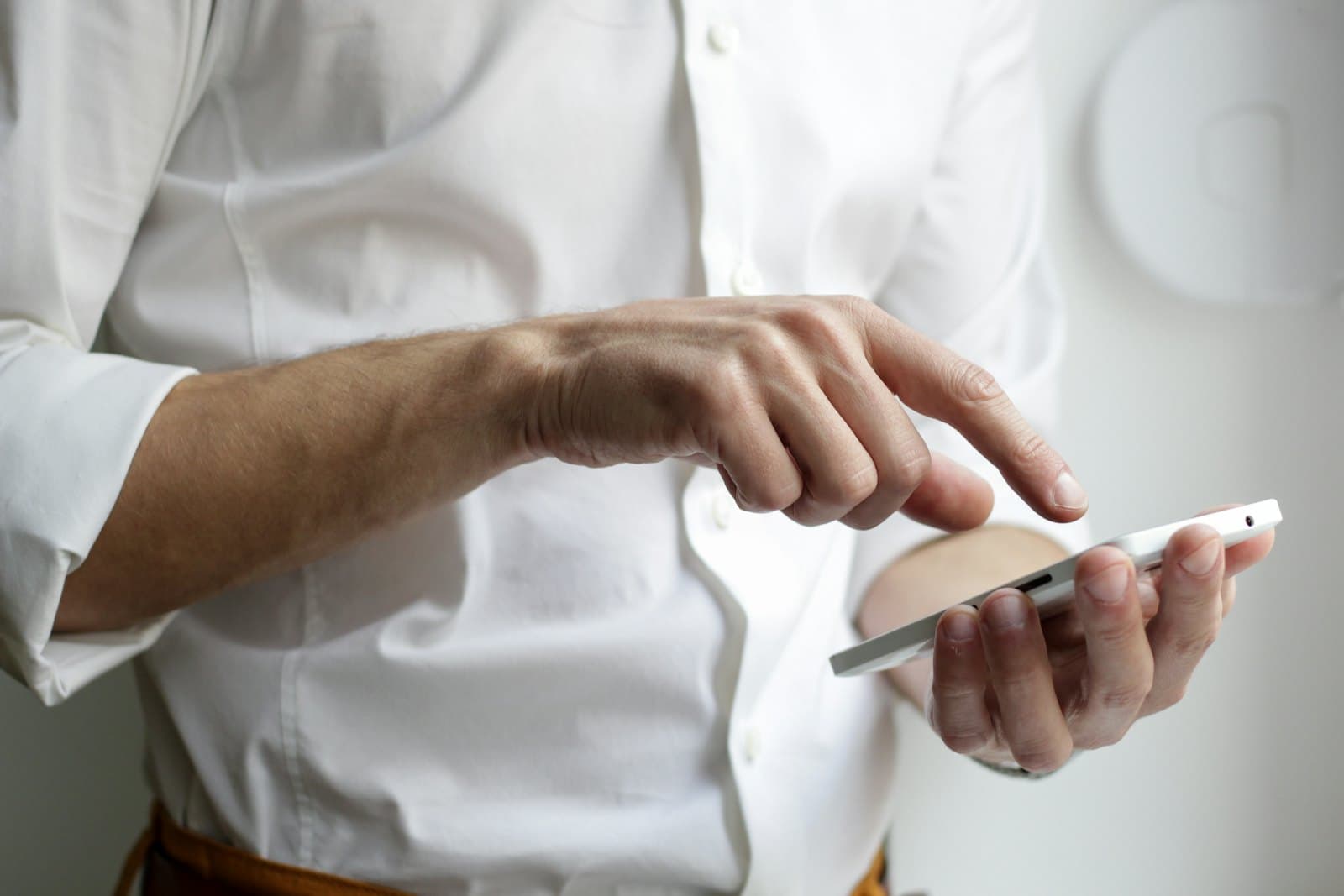 A hand pressing options on a phone screen