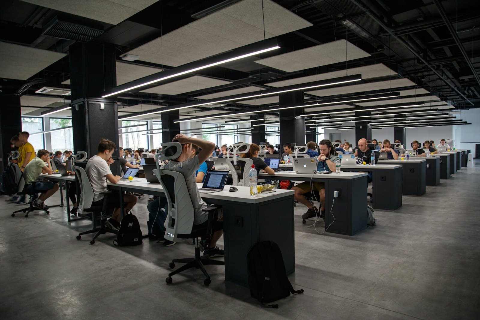A large open-plan floor of agents working at long desks