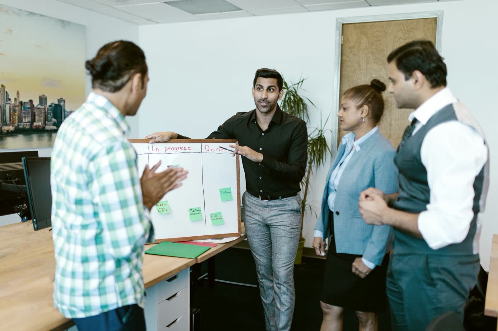A team meeting around a whiteboard