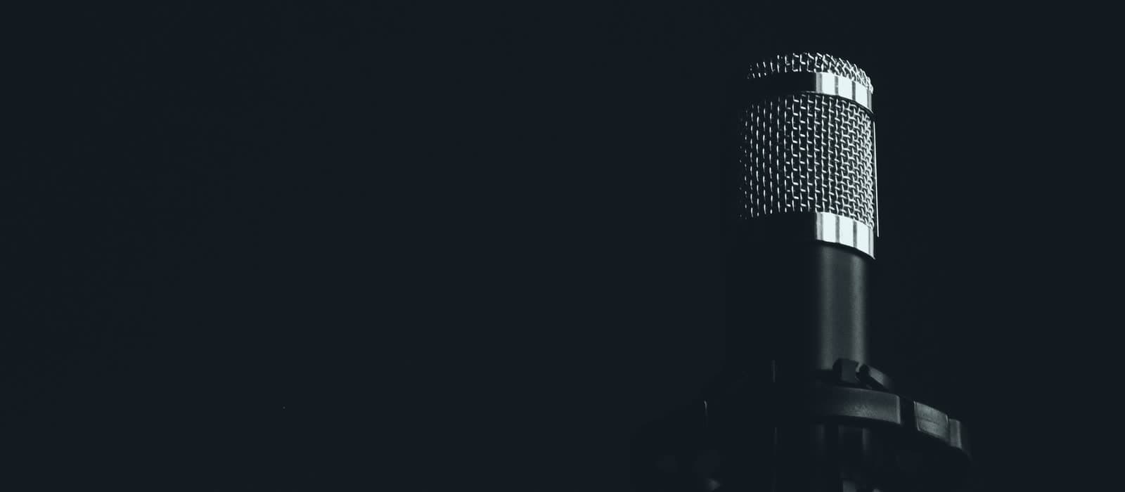 A studio microphone against a dark background